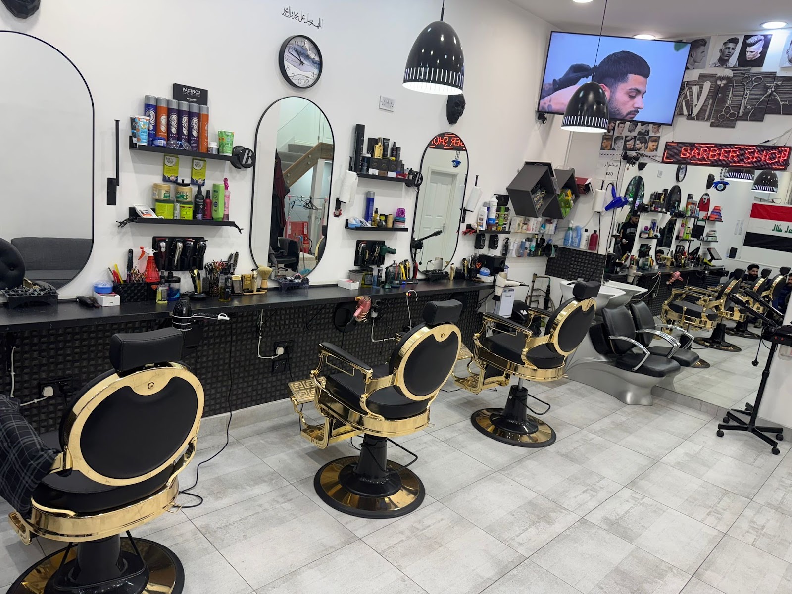 The barbershop interior with a row of black-and-gold chairs and mirrors